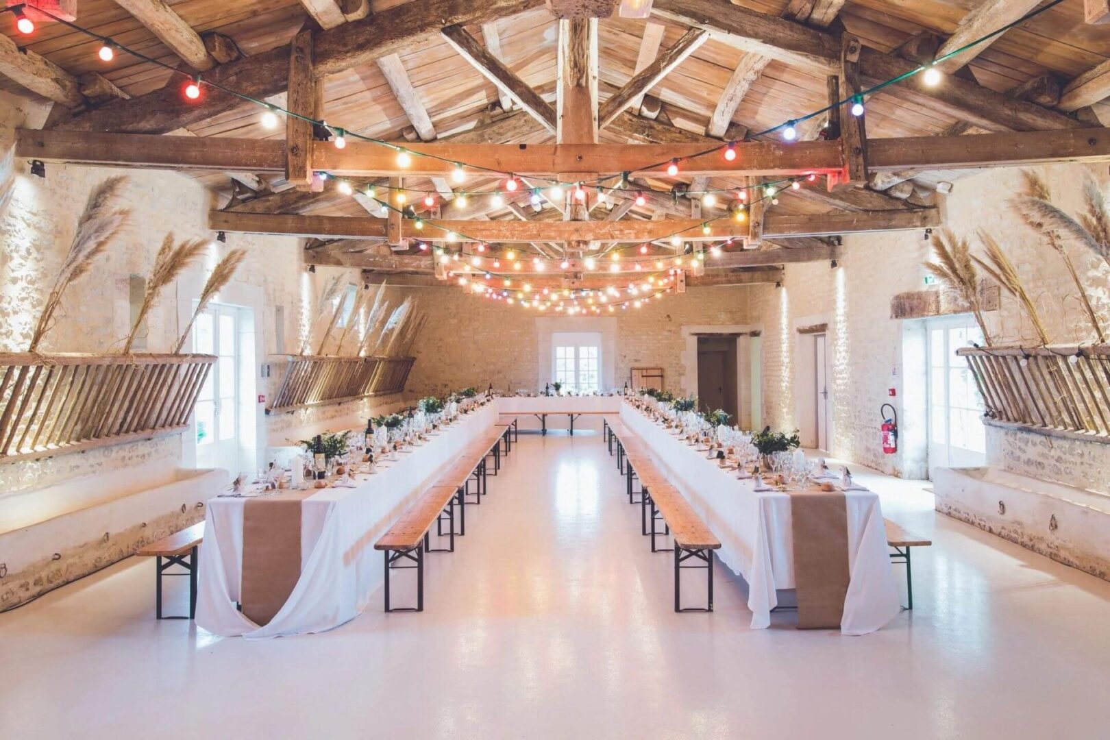 A large room with long tables and benches.